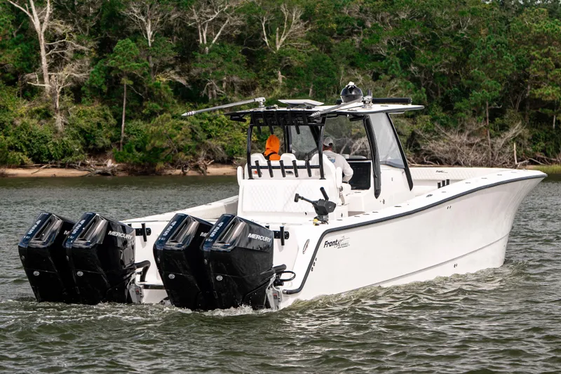  Yacht Photos Pics 2024 Front Runner 37 Catamaran with four Mercury engines cruising on a scenic waterway.