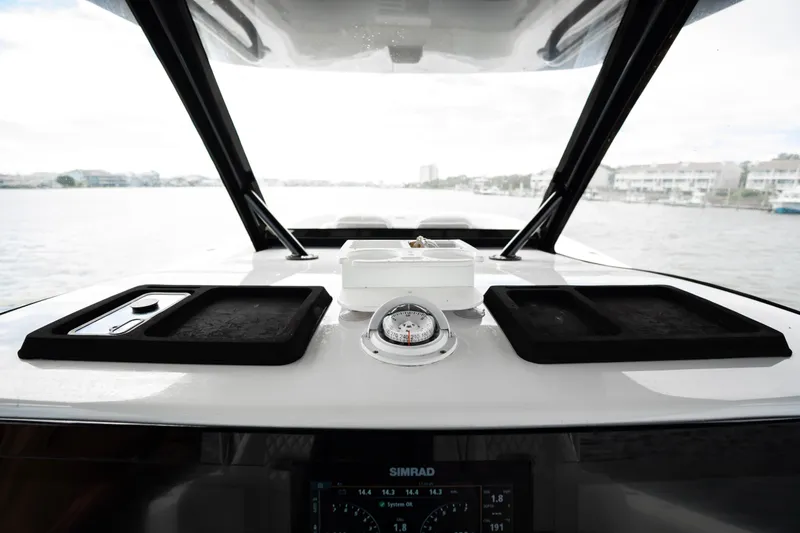  Yacht Photos Pics 2024 Front Runner 37 Catamaran dashboard with navigation instruments and scenic water view.