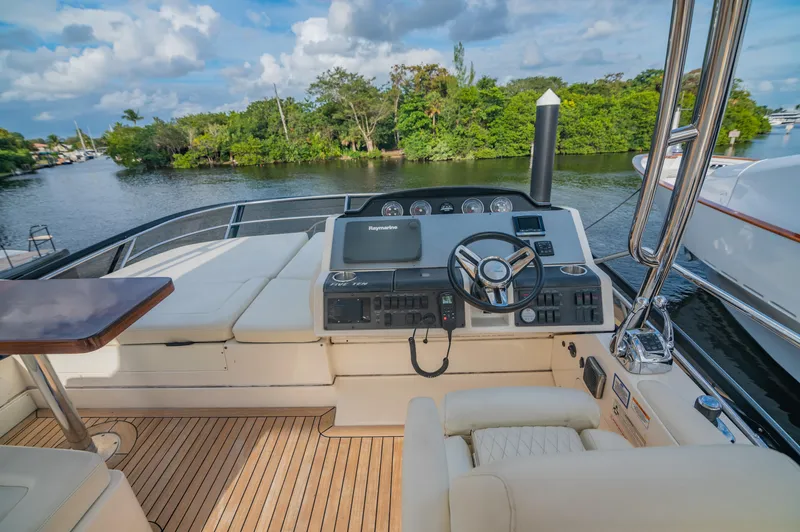 Discover Yacht Photos Pics 2015 Sea Ray 510 Fly yacht helm with scenic river view.