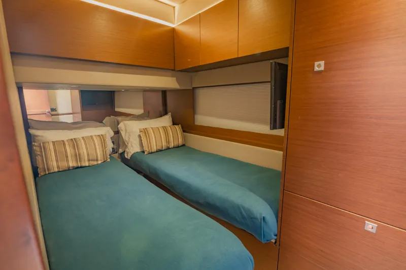 Discover Yacht Photos Pics 2015 Sea Ray 510 Fly cabin with twin beds and modern wood paneling.