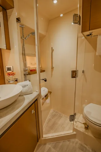 Discover Yacht Photos Pics Luxurious bathroom in 2015 Sea Ray 510 Fly yacht with modern fixtures and glass shower.