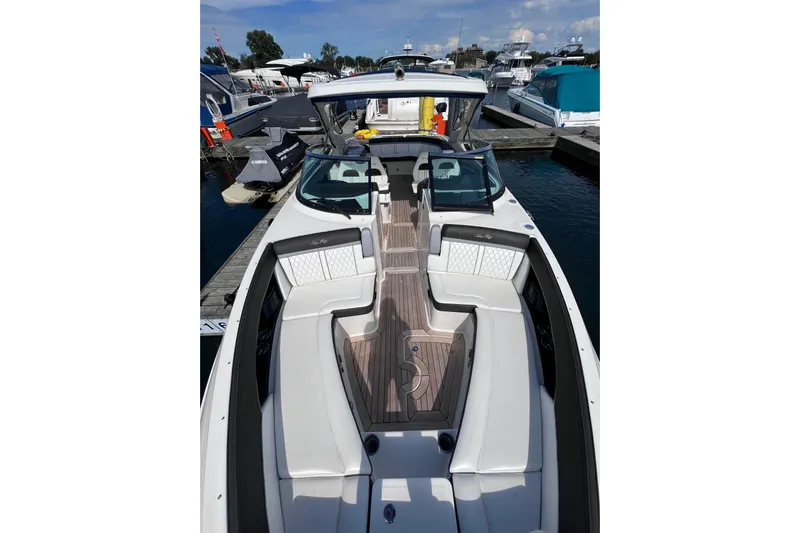  Yacht Photos Pics 2018 Sea Ray SLX 350 boat with spacious seating and sleek design at a marina.