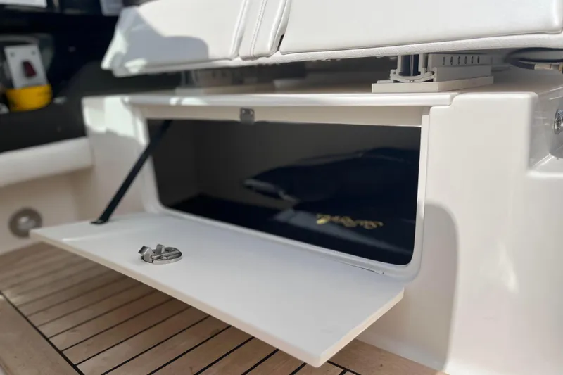  Yacht Photos Pics Open storage compartment on 2018 Sea Ray SLX 350 boat with wooden deck.