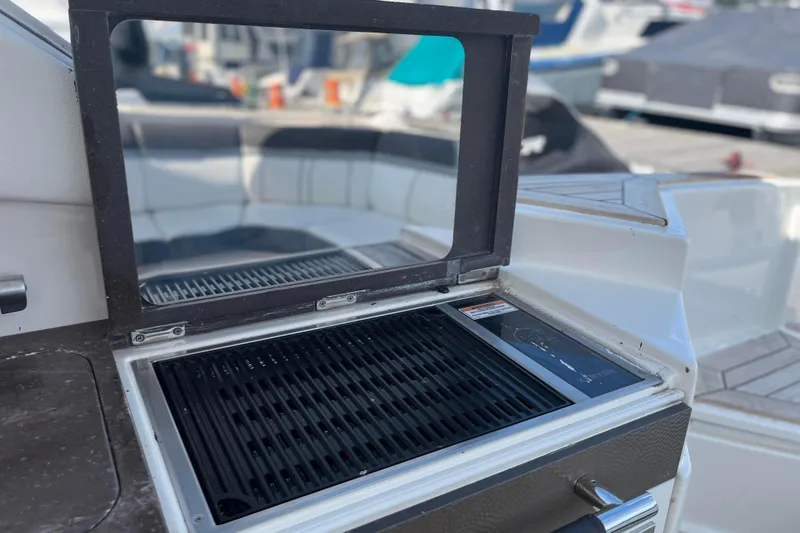  Yacht Photos Pics Outdoor grill on 2018 Sea Ray SLX 350 boat, docked with other vessels nearby.