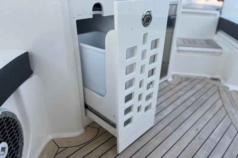  Yacht Photos Pics 2018 Sea Ray SLX 350 boat interior with open storage compartment and wooden flooring.