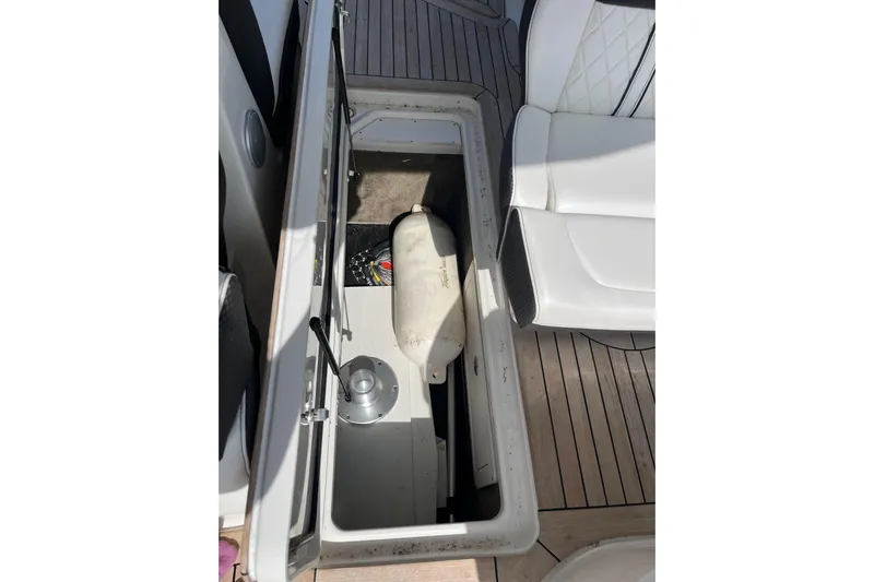  Yacht Photos Pics Storage compartment on 2018 Sea Ray SLX 350 boat with white seating and wooden deck.