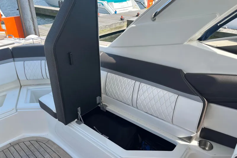  Yacht Photos Pics 2018 Sea Ray SLX 350 boat interior with open storage compartment and cushioned seating.