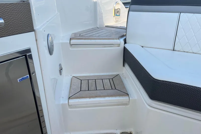  Yacht Photos Pics Interior view of 2018 Sea Ray SLX 350 boat with cushioned seating and wooden steps.