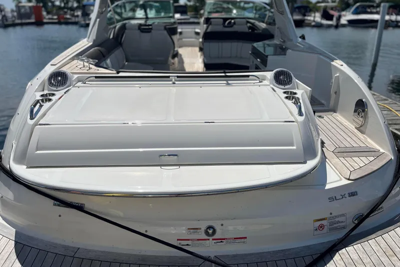  Yacht Photos Pics 2018 Sea Ray SLX 350 boat docked, showcasing spacious deck and seating area.
