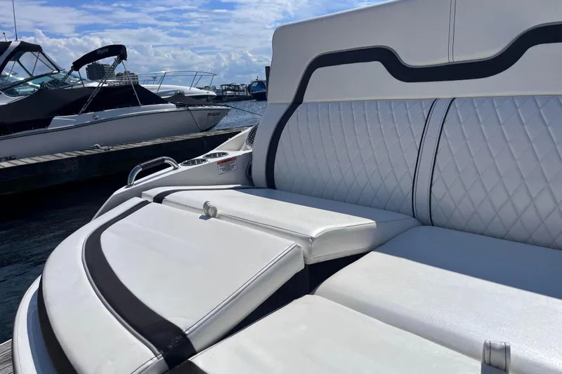  Yacht Photos Pics Luxurious seating on a 2018 Sea Ray SLX 350 boat, docked under a clear sky.