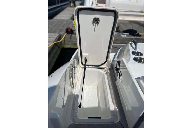  Yacht Photos Pics Open storage compartment on a 2018 Sea Ray SLX 350 boat, dockside view.