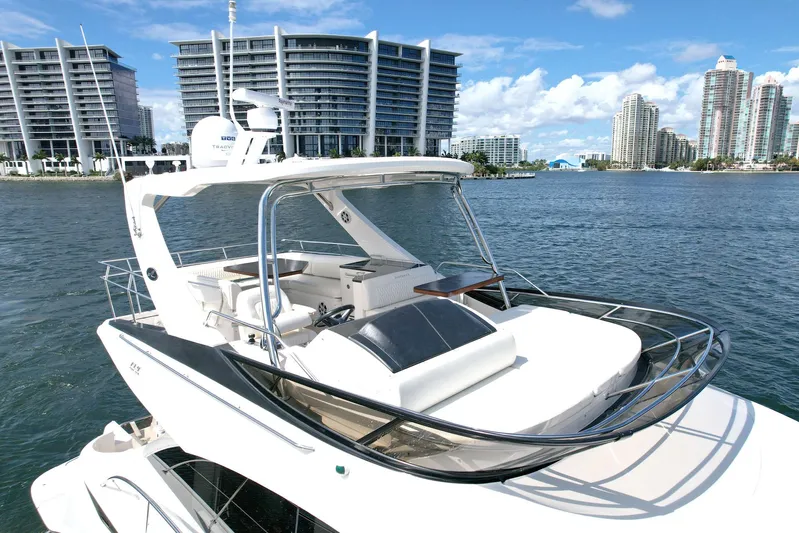 Discover Yacht Photos Pics 2015 Sea Ray 510 Fly yacht on water with city skyline background.