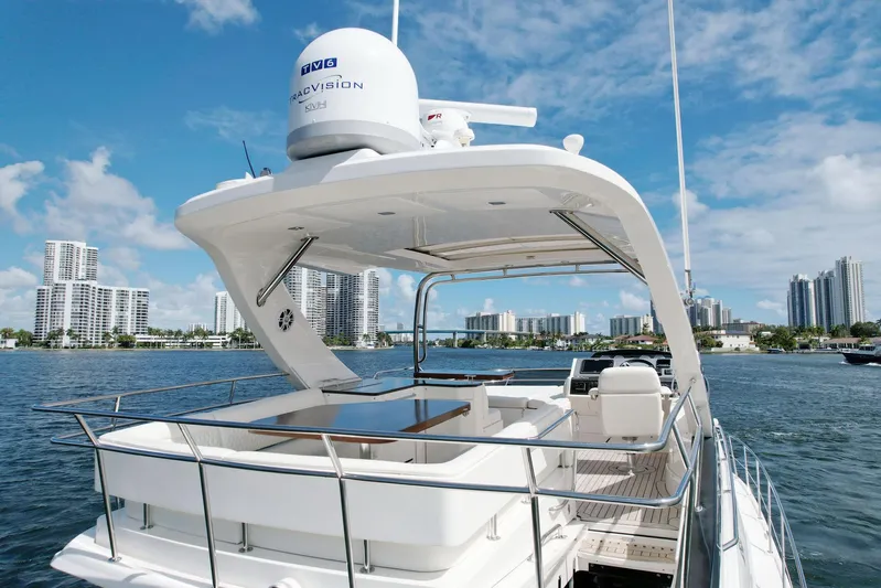 Discover Yacht Photos Pics 2015 Sea Ray 510 Fly yacht on water with city skyline in background.