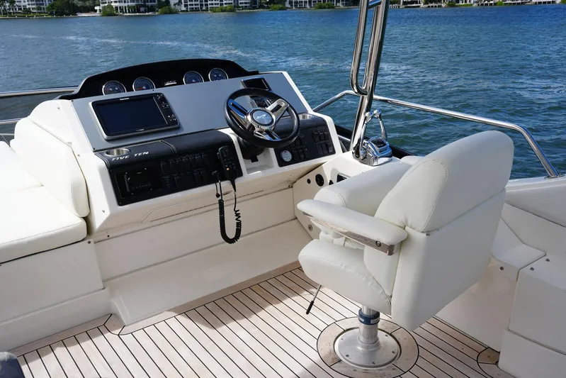 Discover Yacht Photos Pics 2015 Sea Ray 510 Flybridge helm with modern controls and comfortable seating.