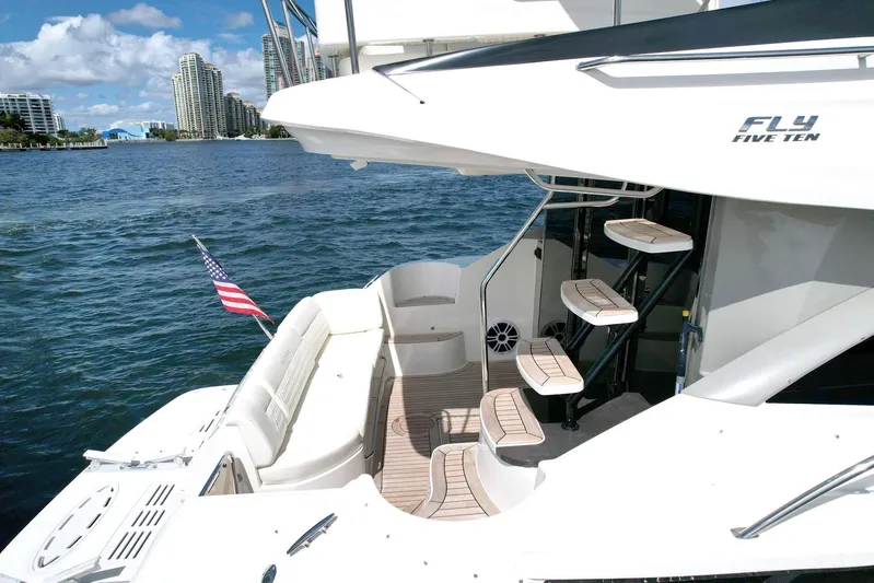 Discover Yacht Photos Pics Luxurious 2015 Sea Ray 510 Fly yacht on serene water, featuring elegant deck and seating.