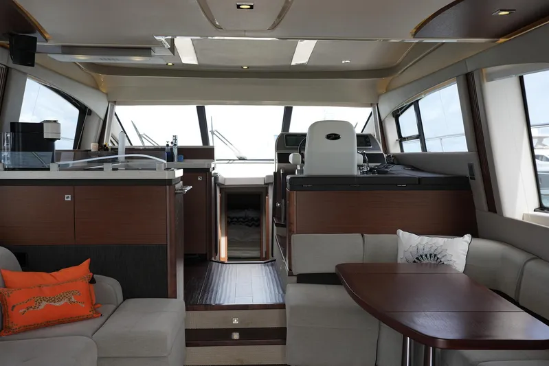Discover Yacht Photos Pics Luxurious interior of 2015 Sea Ray 510 Fly yacht with modern furnishings and helm station.