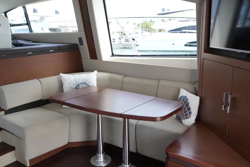 Discover Yacht Photos Pics Luxurious interior of 2015 Sea Ray 510 Fly yacht with elegant seating and table.