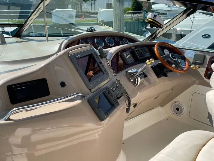  Yacht Photos Pics Interior helm of 2000 Sea Ray 460 Sundancer yacht with navigation equipment and steering wheel.