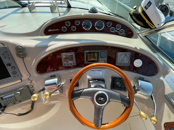  Yacht Photos Pics Cockpit of 2000 Sea Ray 460 Sundancer with wooden steering wheel and navigation instruments.
