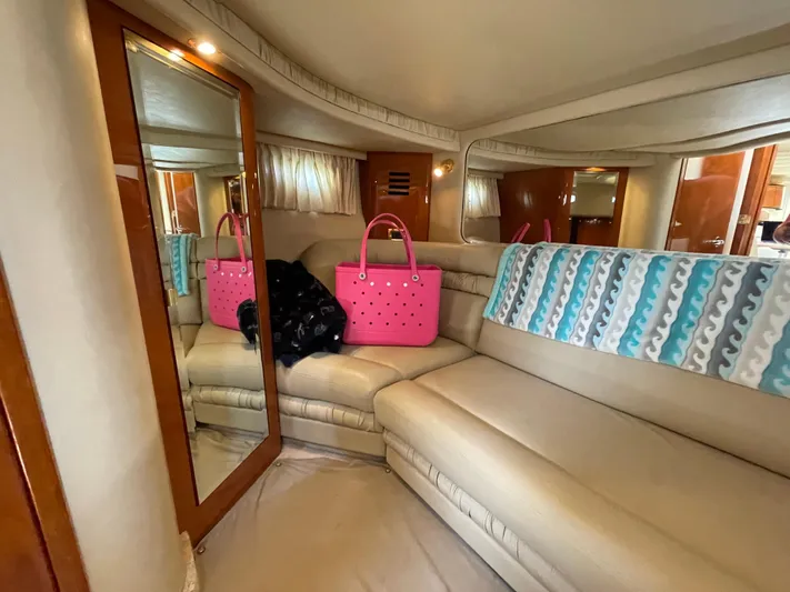  Yacht Photos Pics Luxurious interior of 2000 Sea Ray 460 Sundancer yacht with beige seating and pink bag.