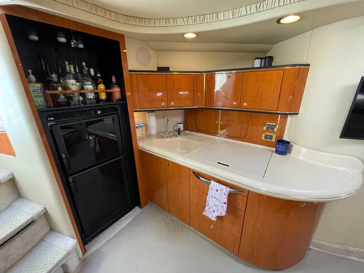  Yacht Photos Pics Luxurious 2000 Sea Ray 460 Sundancer yacht kitchen with wood cabinets and bar area.