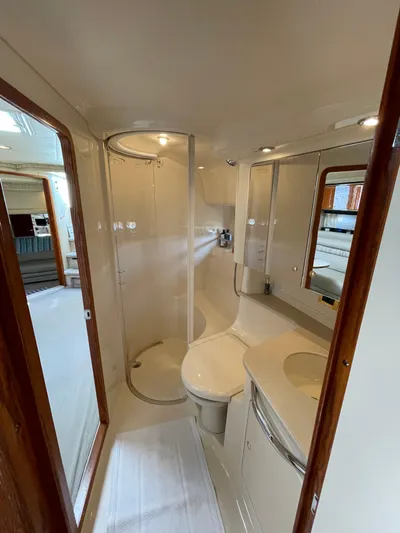  Yacht Photos Pics Luxurious bathroom in 2000 Sea Ray 460 Sundancer yacht, featuring modern fixtures and elegant design.