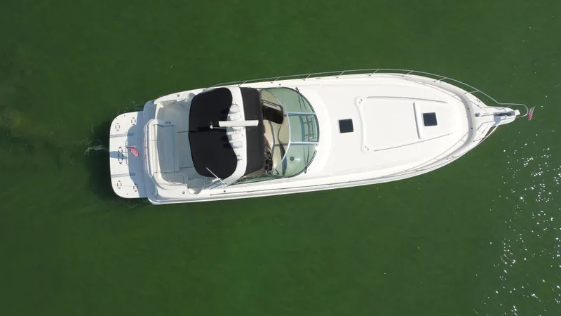 Yacht Photos Pics Aerial view of 2000 Sea Ray 460 Sundancer yacht on green water.