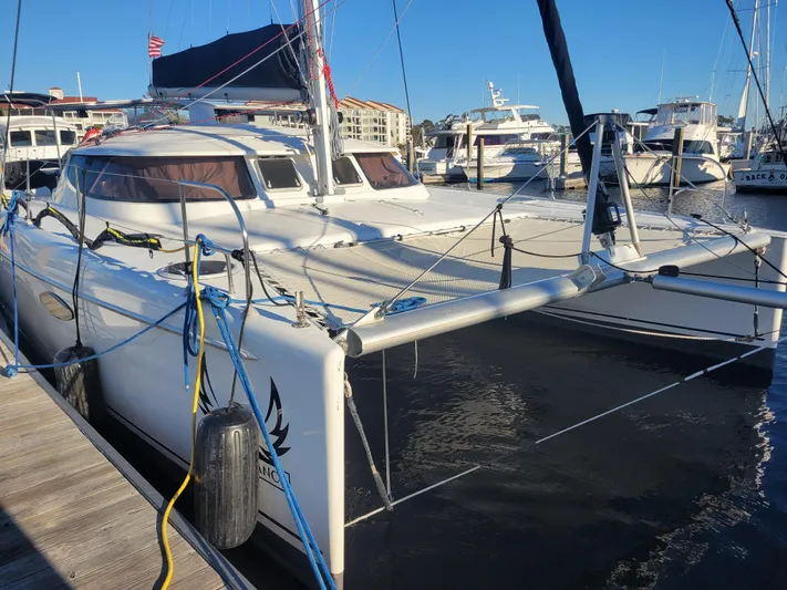  Yacht Photos Pics 2006 Fountaine Pajot LAVEZZI catamaran docked at marina, surrounded by other boats.