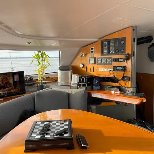  Yacht Photos Pics Interior of 2006 Fountaine Pajot LAVEZZI catamaran with control panel, seating, and chessboard.