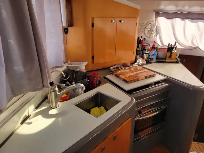  Yacht Photos Pics 2006 Fountaine Pajot LAVEZZI yacht kitchen with modern appliances and wooden cabinetry.