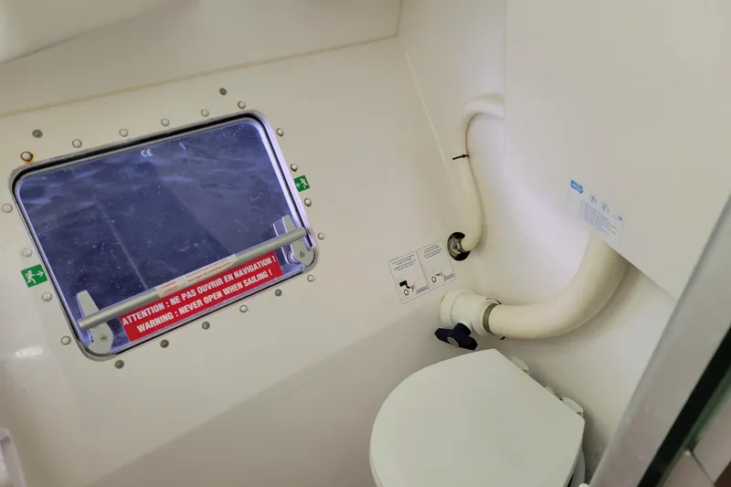  Yacht Photos Pics Bathroom interior of 2006 Fountaine Pajot LAVEZZI catamaran with window and toilet.