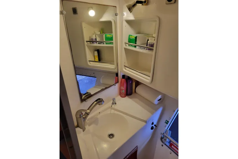  Yacht Photos Pics Bathroom sink area in 2006 Fountaine Pajot LAVEZZI catamaran with mirror and toiletries.