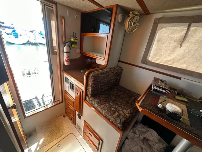 Firefly Yacht Photos Pics 2008 Davis Rock Harbor boat interior with seating, storage, and window view of marina.