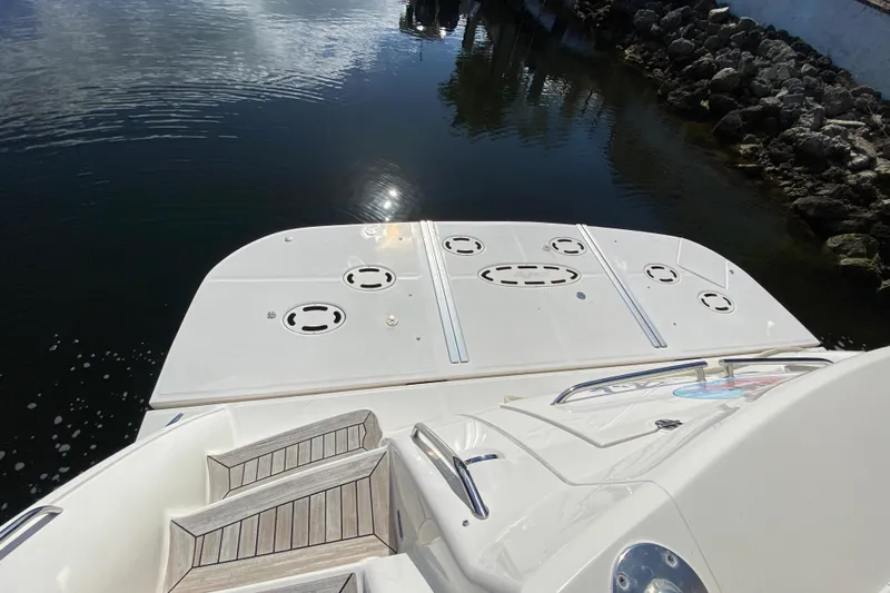  Yacht Photos Pics 2012 Sea Ray 610 Sundancer yacht stern view with swim platform and water reflection.