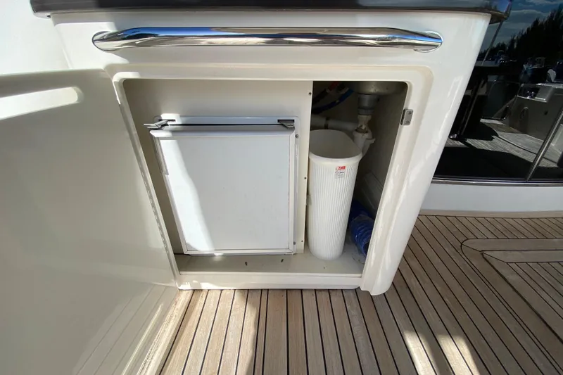  Yacht Photos Pics Storage compartment on 2012 Sea Ray 610 Sundancer yacht with mini fridge and waste bin.