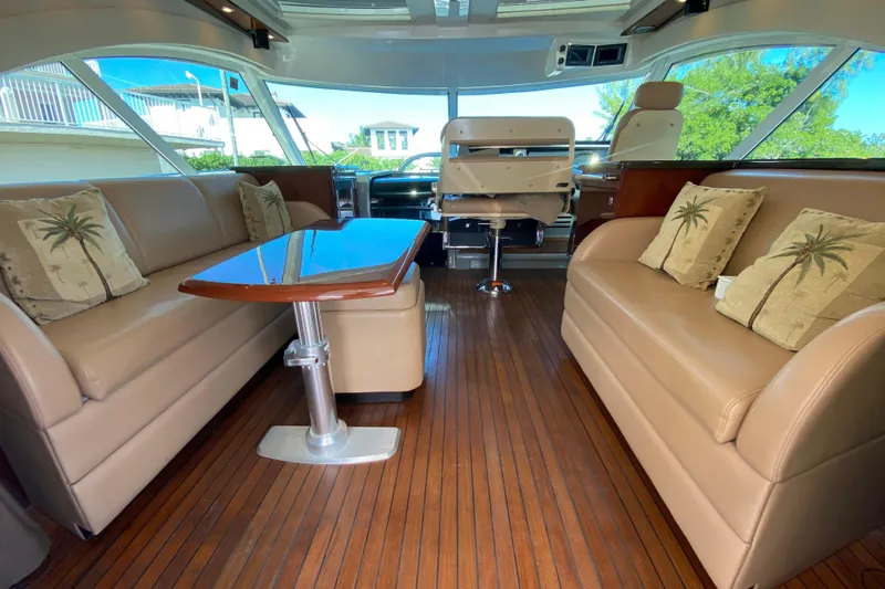  Yacht Photos Pics Luxurious interior of 2012 Sea Ray 610 Sundancer yacht with elegant seating and wooden flooring.