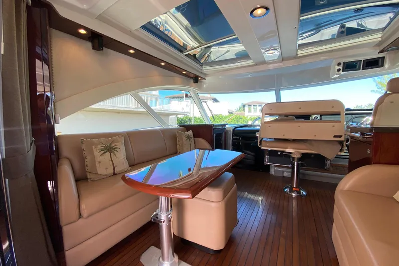  Yacht Photos Pics Luxurious interior of 2012 Sea Ray 610 Sundancer yacht with elegant seating and wooden flooring.