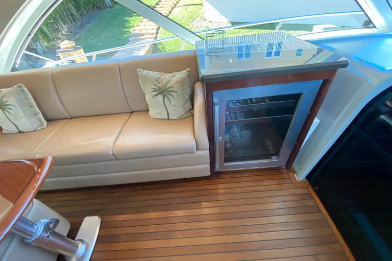  Yacht Photos Pics Luxurious interior of 2012 Sea Ray 610 Sundancer with sofa and mini fridge.