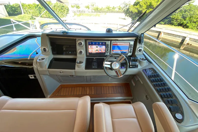  Yacht Photos Pics Cockpit of 2012 Sea Ray 610 Sundancer with modern navigation system and leather seating.