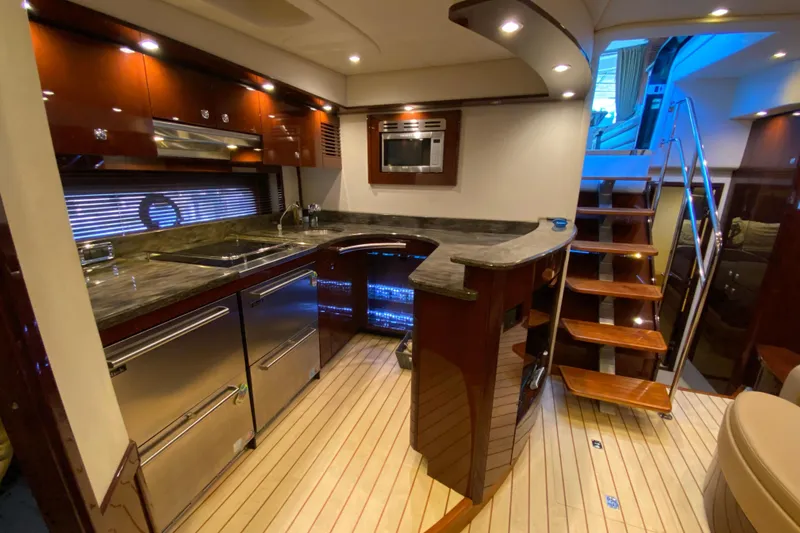  Yacht Photos Pics Luxurious interior of 2012 Sea Ray 610 Sundancer yacht with modern kitchen and wooden stairs.