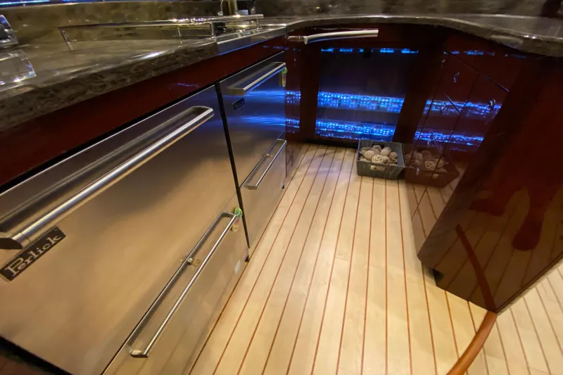  Yacht Photos Pics Luxurious kitchen interior of 2012 Sea Ray 610 Sundancer yacht with stainless steel appliances.