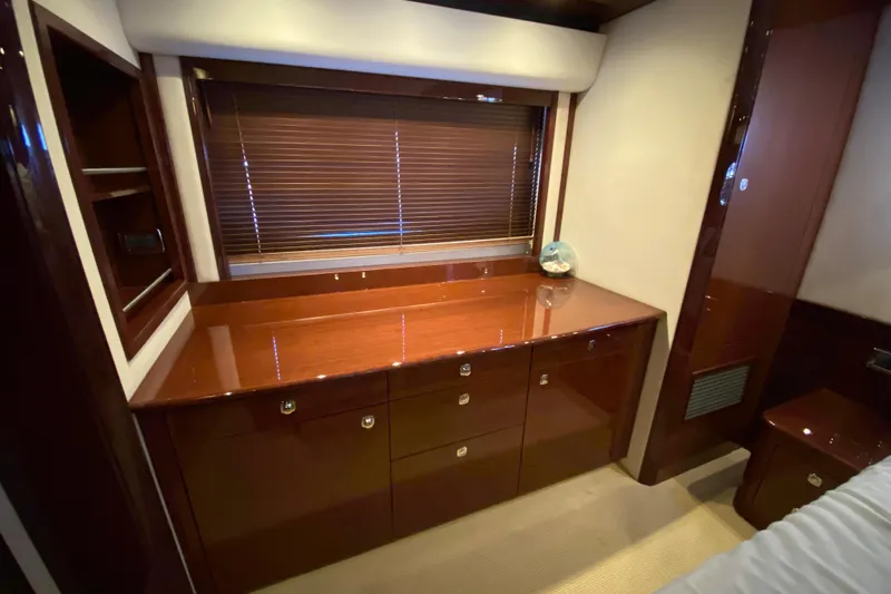  Yacht Photos Pics Luxurious interior of 2012 Sea Ray 610 Sundancer yacht with wooden cabinetry and window blinds.