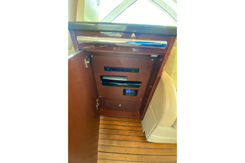  Yacht Photos Pics 2012 Sea Ray 610 Sundancer interior cabinet with electronic controls and wooden flooring.