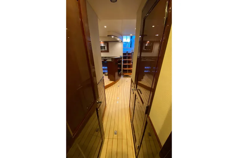  Yacht Photos Pics Luxurious interior hallway of 2012 Sea Ray 610 Sundancer yacht with wooden flooring.