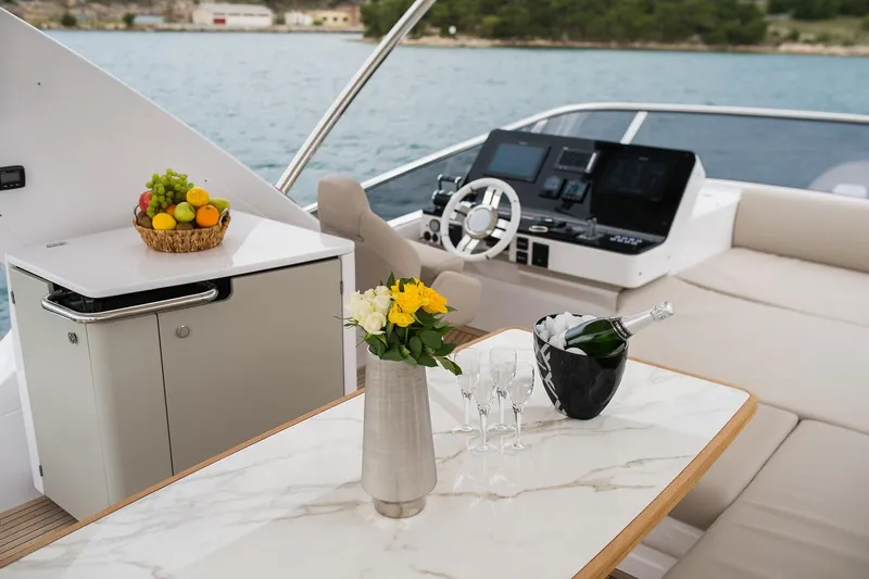 Mawi Yacht Photos Pics Luxurious 2019 Azimut FLY 55 yacht interior with marble table, fruit basket, and champagne.