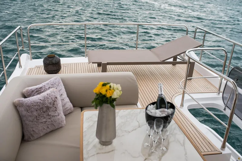Mawi Yacht Photos Pics Luxurious Azimut FLY 55 yacht deck with lounge, flowers, and champagne, 2019 model.
