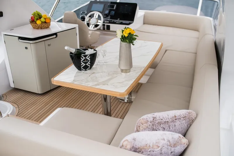 Mawi Yacht Photos Pics Luxurious interior of 2019 Azimut FLY 55 yacht with elegant seating and dining area.