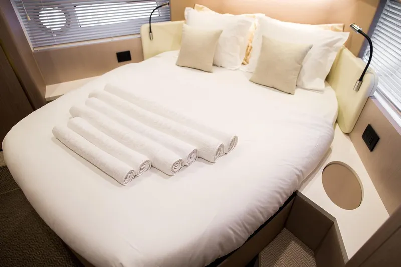 Mawi Yacht Photos Pics Luxurious bedroom in 2019 Azimut FLY 55 yacht with neatly arranged towels.