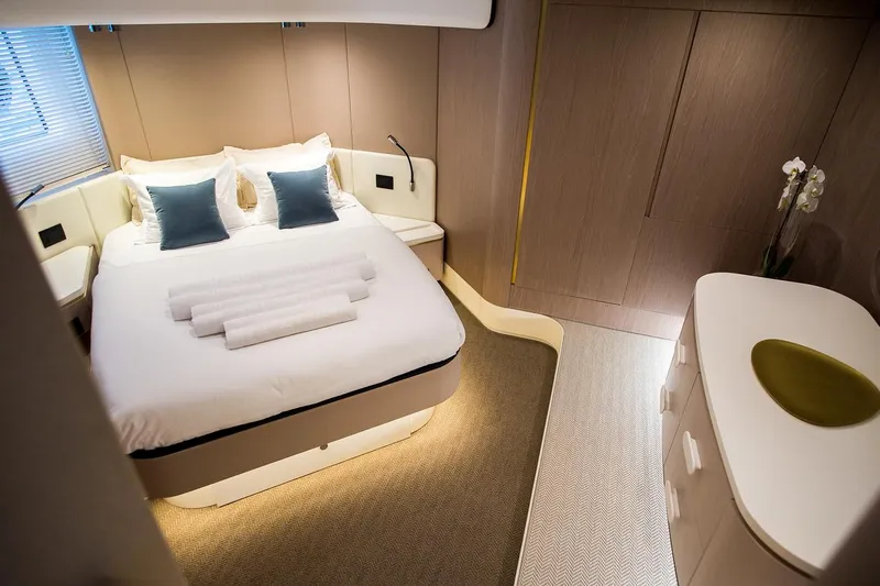 Mawi Yacht Photos Pics Luxurious bedroom interior of 2019 Azimut FLY 55 yacht with elegant decor and cozy bedding.