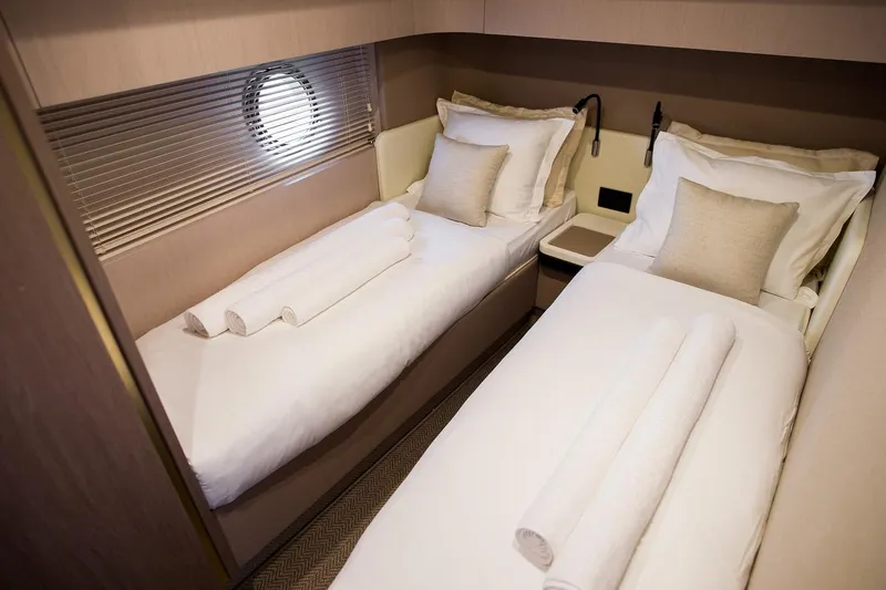 Mawi Yacht Photos Pics Luxurious twin cabin interior on 2019 Azimut FLY 55 yacht, featuring elegant bedding and decor.